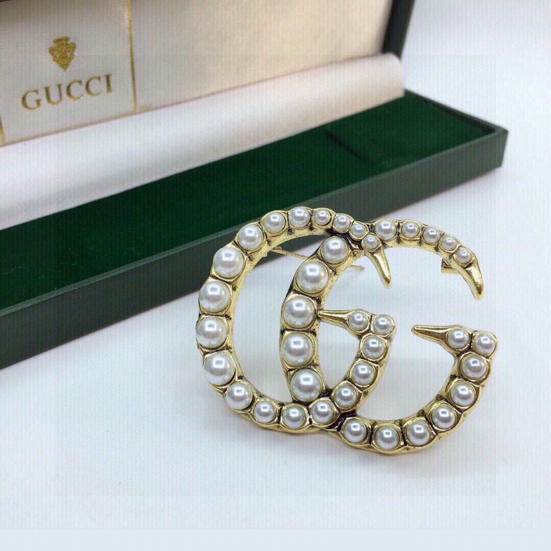 G*u*i brooches